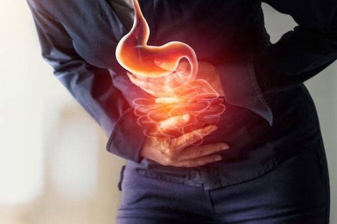 Woman holding stomach in discomfort — weight management for GERD Symptoms, acid reflux, and heartburn relief